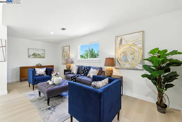 a living room with furniture and a potted plant