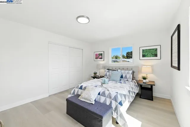 a bedroom with a bed and a painting