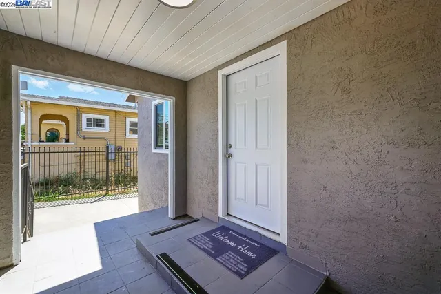 a living room with furniture wooden floor and a large window