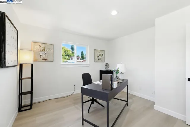 a view of a house with a yard and potted plants