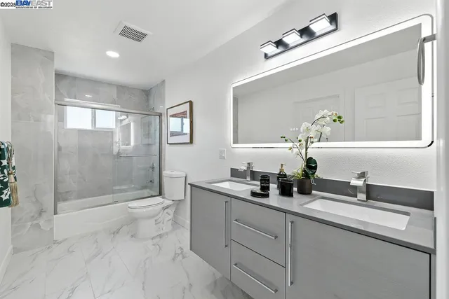 a view of a yard with wooden fence