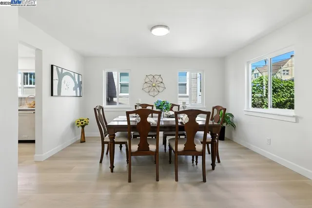 a view of a dining room with furniture and a potted plant