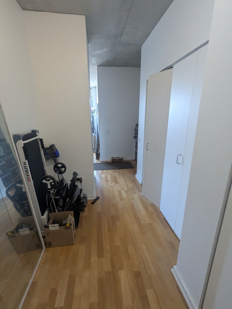 659 West Randolph Street, Unit 711 Chicago, IL 60661 - Photo 12 of 14 a room with wooden floor and furniture