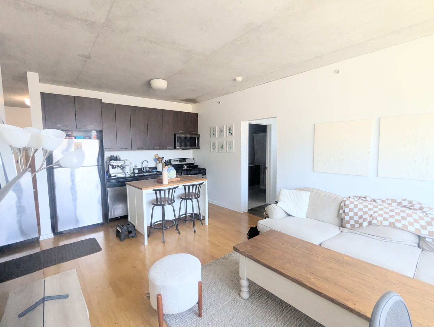 659 West Randolph Street, Unit 711 Chicago, IL 60661 - Photo 2 of 14 a living room with furniture and kitchen view