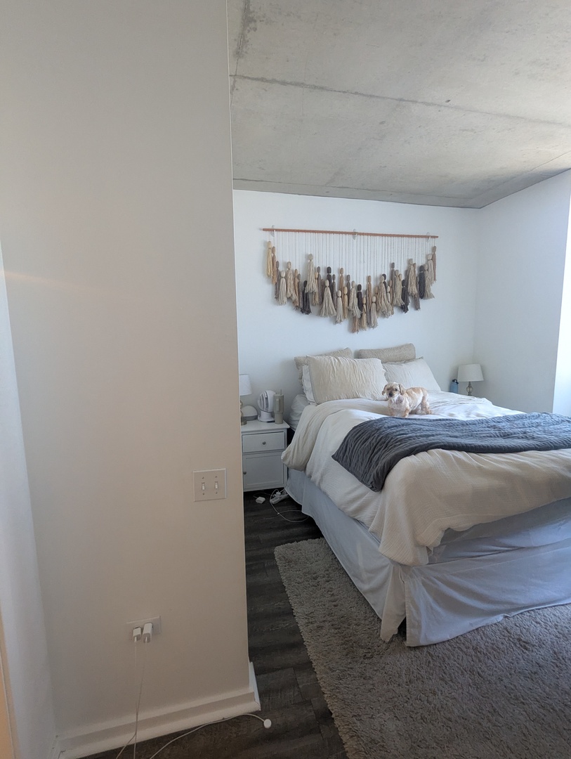659 West Randolph Street, Unit 711 Chicago, IL 60661 - Photo 6 of 14 a bedroom with a bed and a table