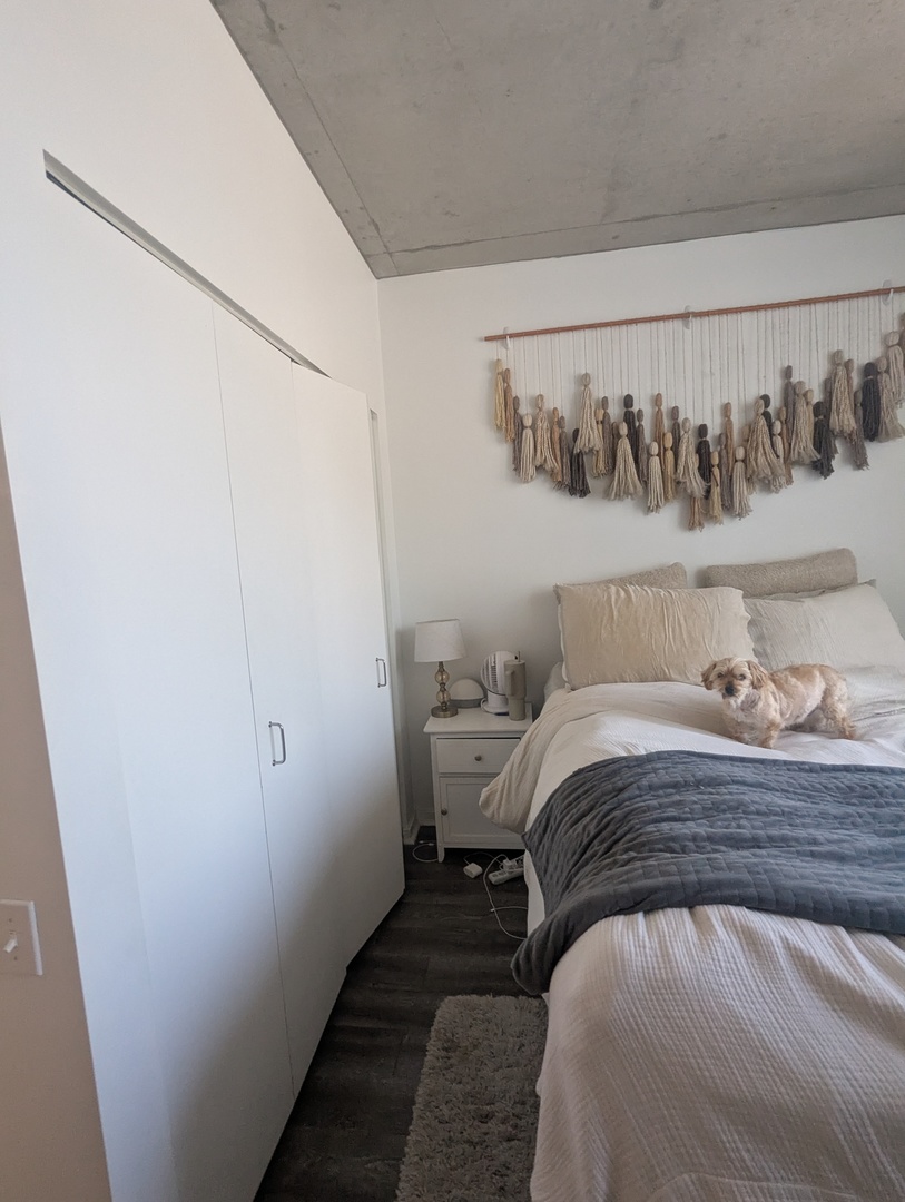 659 West Randolph Street, Unit 711 Chicago, IL 60661 - Photo 9 of 14 a bedroom with a bed and lamp