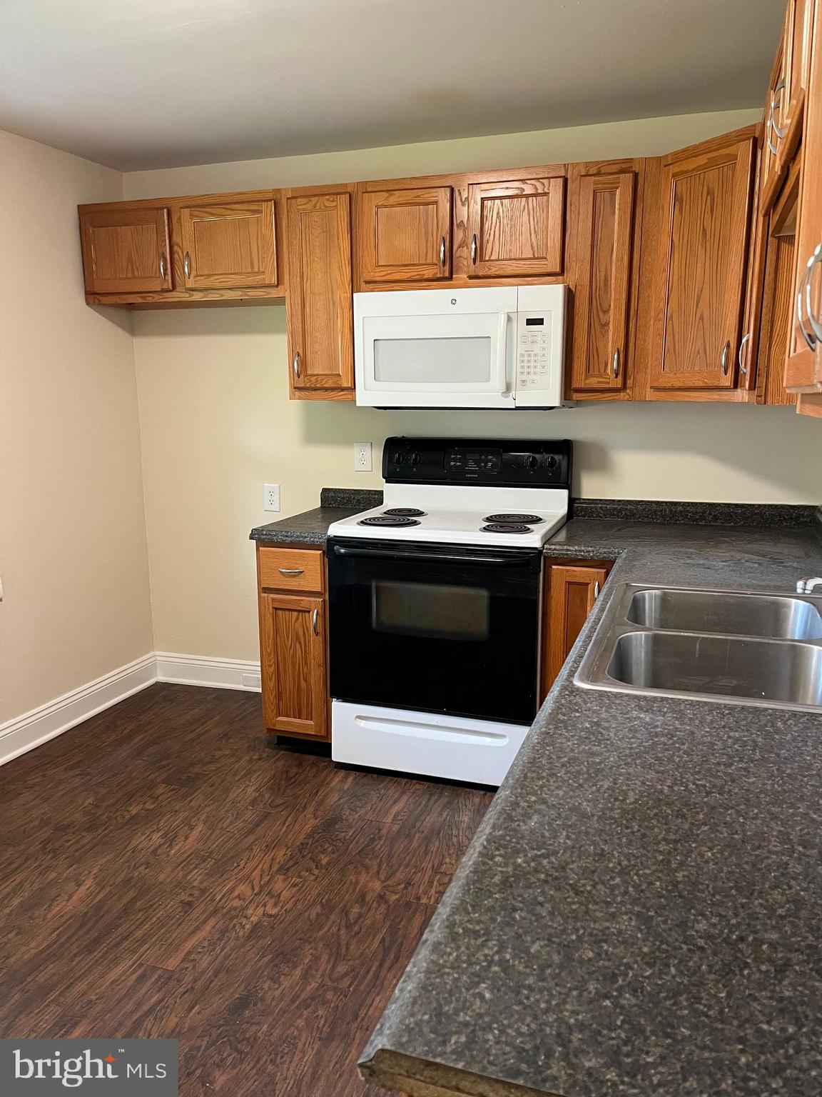 246 South Ironstone Drive Boyertown, PA 19512 - Photo 4 of 9 a kitchen with wooden floor and a stove top oven