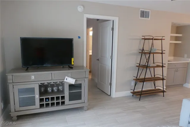 a living room with a flat screen tv and a table