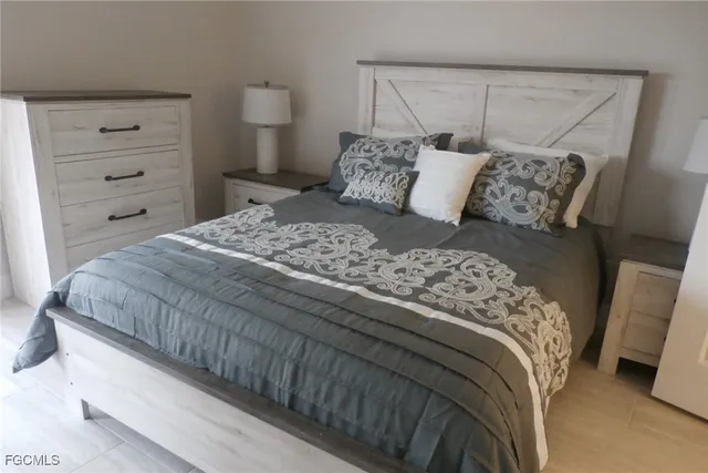 a bedroom with a bed and a night stand