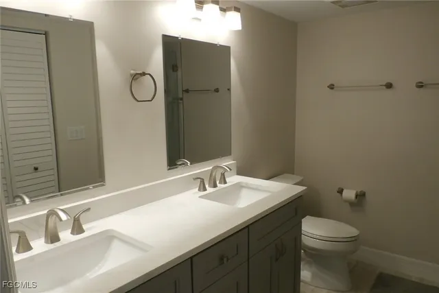 a bathroom with a sink toilet and mirror
