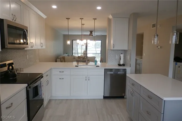 a kitchen with a sink stove and refrigerator