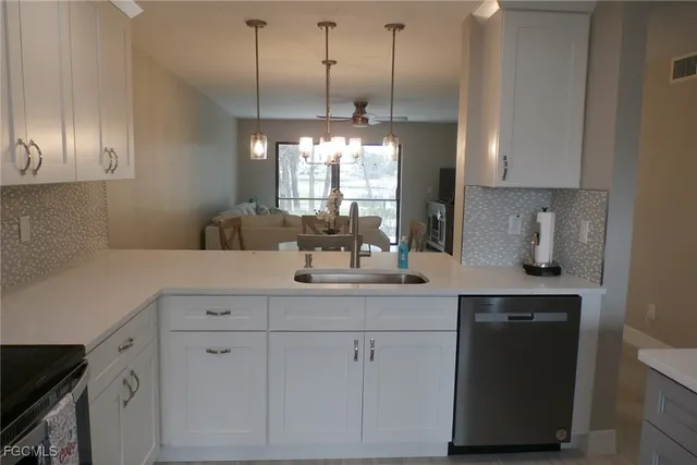 a kitchen with cabinets appliances and a window