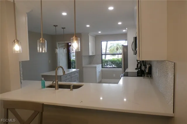a large white kitchen with a large window