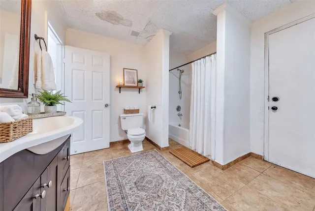a spacious bathroom with a bathtub shower sink and toilet