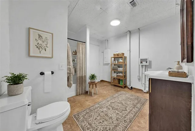 a spacious bathroom with a sink a toilet and shower