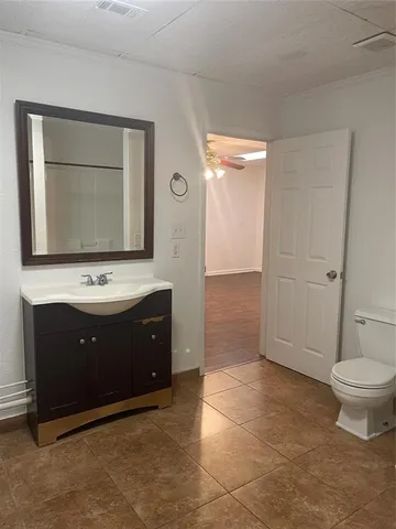 a bathroom with a sink a toilet and a mirror