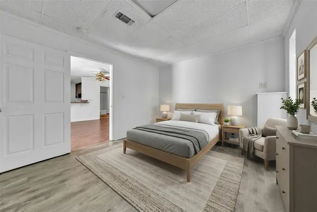 a spacious bedroom with a bed and cabinets