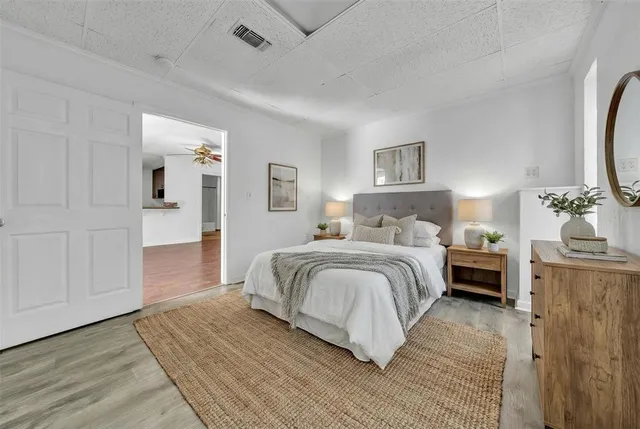 a spacious bedroom with a bed and cabinets