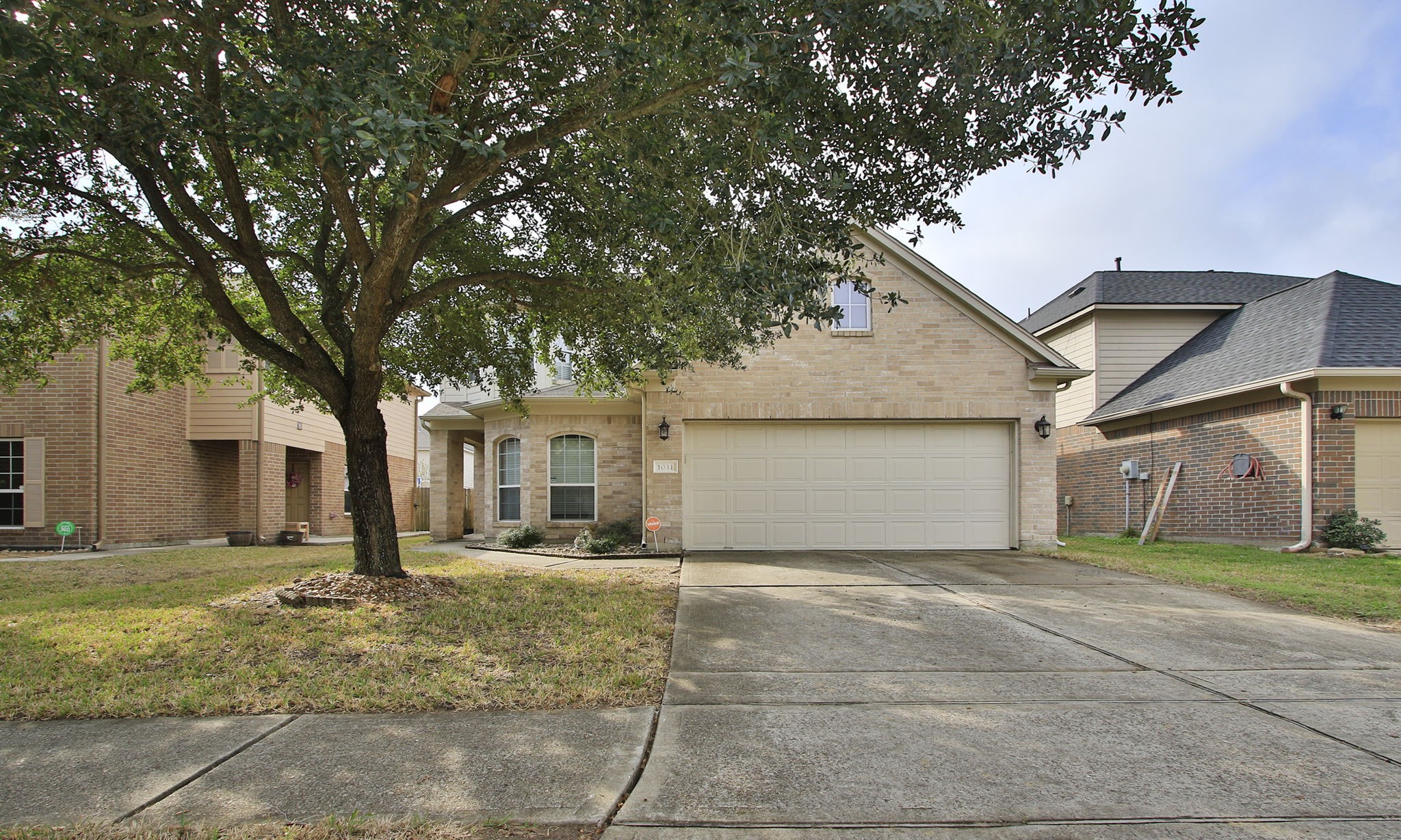a front view of a house with a yard and garage