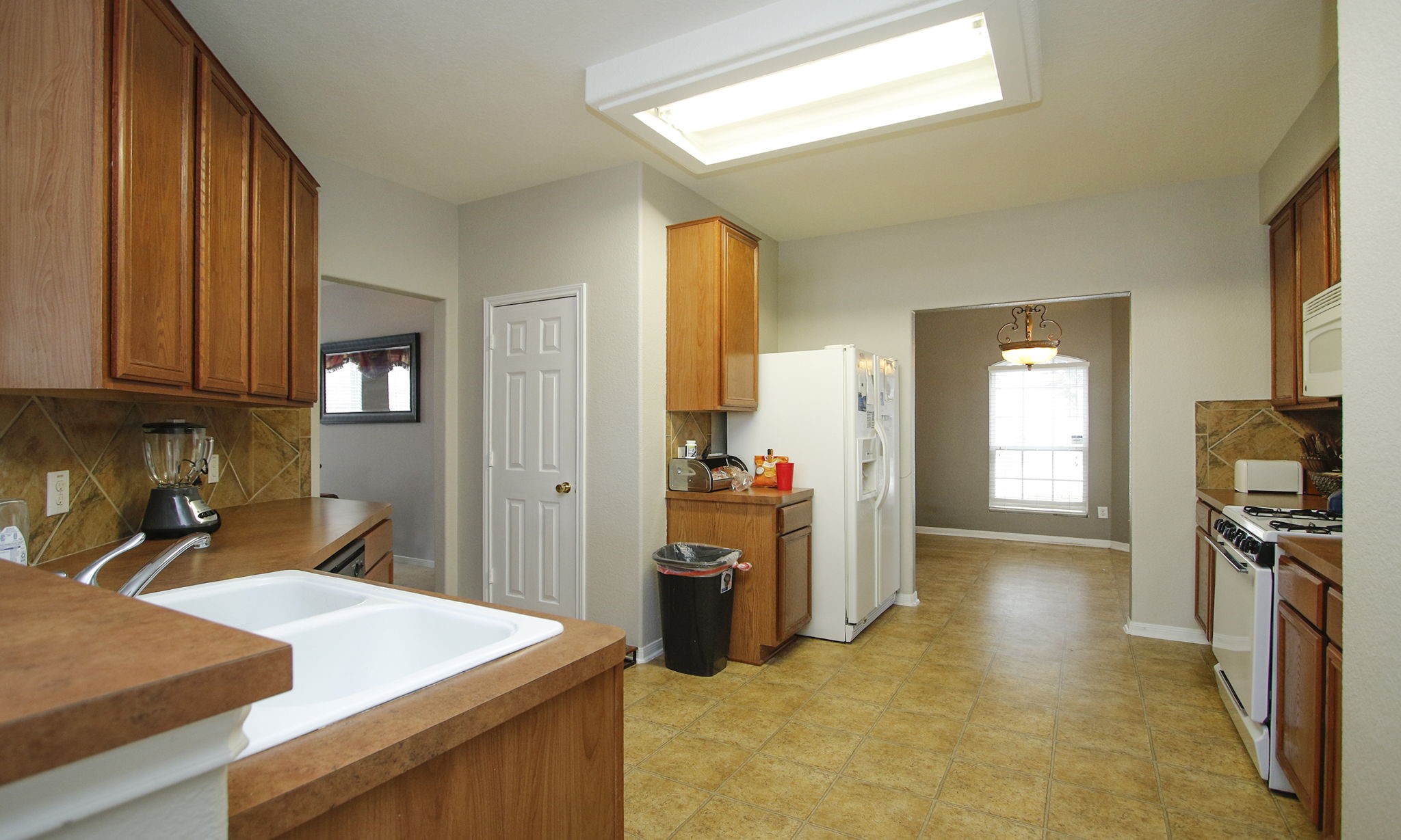 1031 Spring Heights Drive Spring, TX 77373 - Photo 12 of 41 a kitchen that has a sink and a stove in it