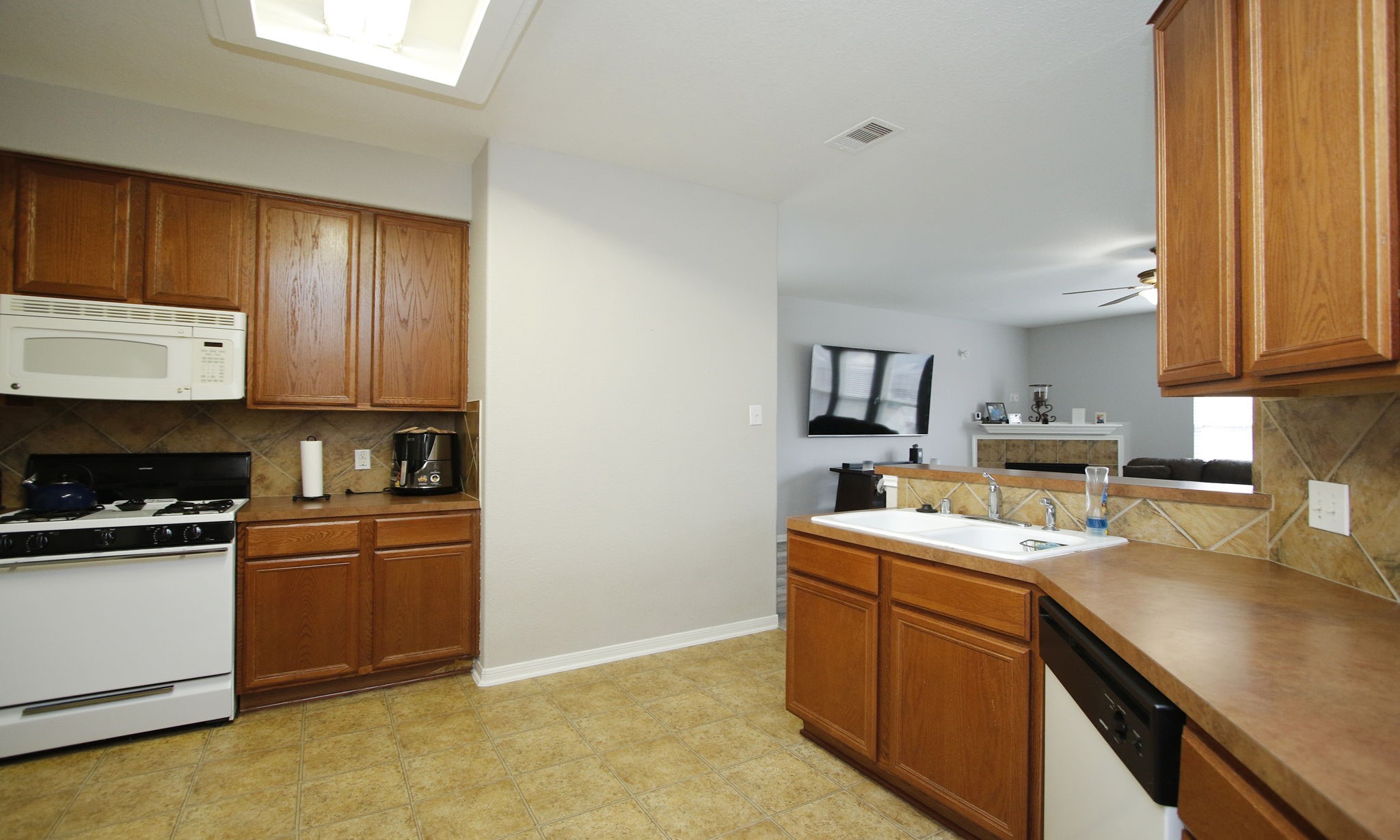 1031 Spring Heights Drive Spring, TX 77373 - Photo 14 of 41 a kitchen with stainless steel appliances granite countertop a sink stove and cabinets