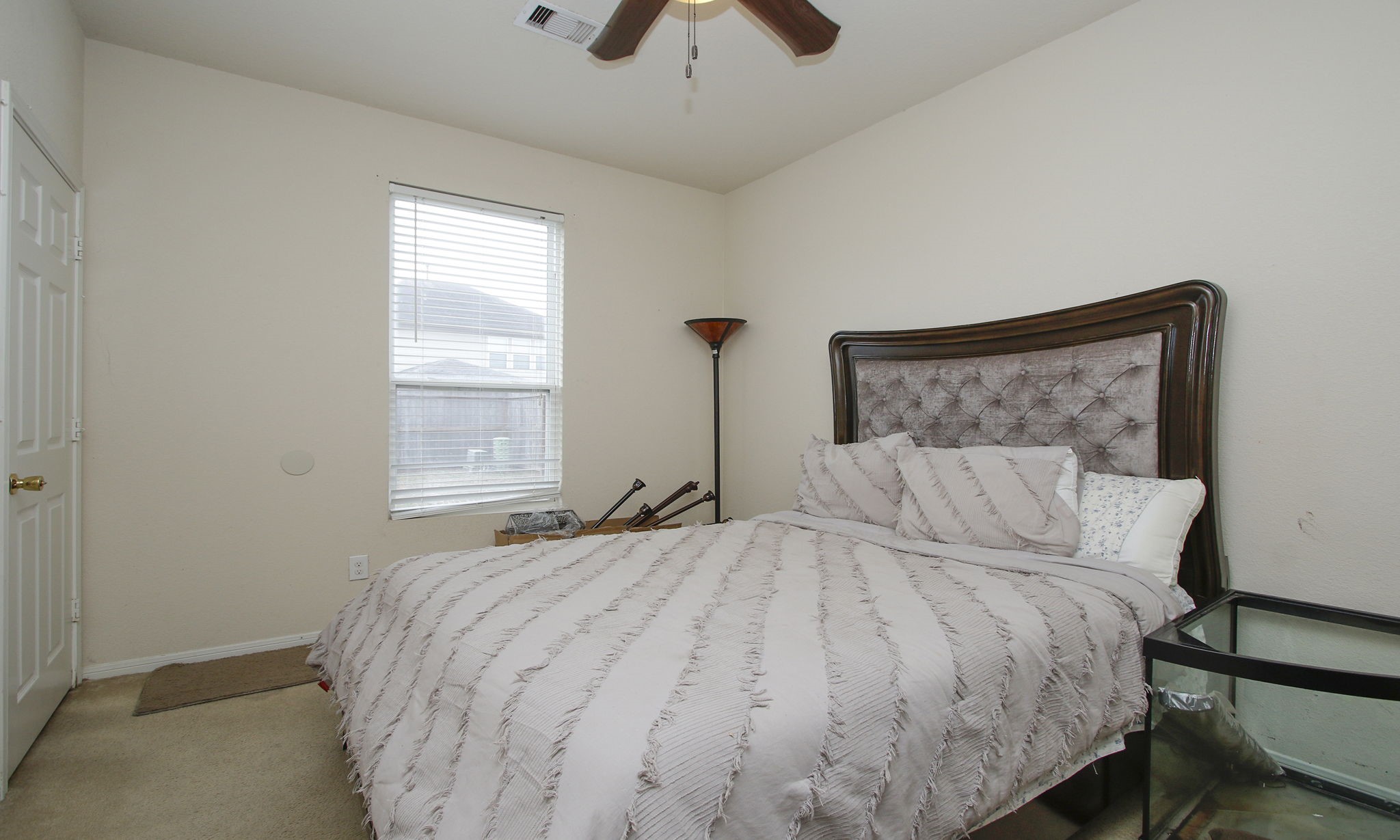 1031 Spring Heights Drive Spring, TX 77373 - Photo 20 of 41 a bedroom with a large bed and a chandelier
