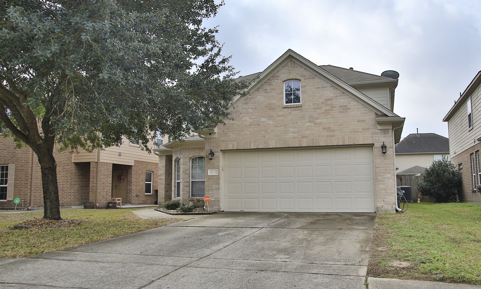 1031 Spring Heights Drive Spring, TX 77373 - Photo 2 of 41 a front view of a house with a yard and garage