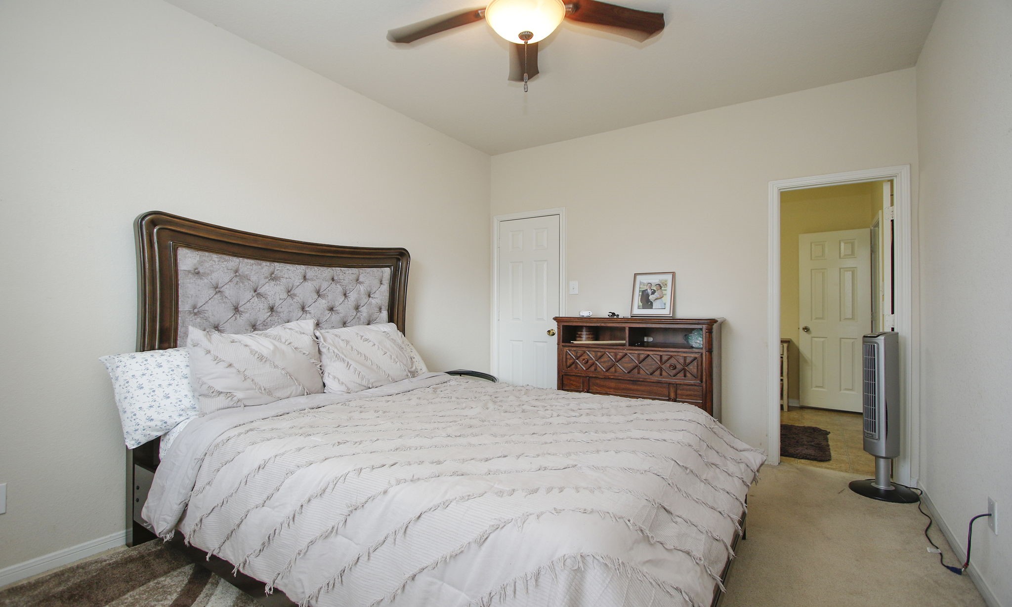 1031 Spring Heights Drive Spring, TX 77373 - Photo 21 of 41 a bedroom with a bed and a chandelier