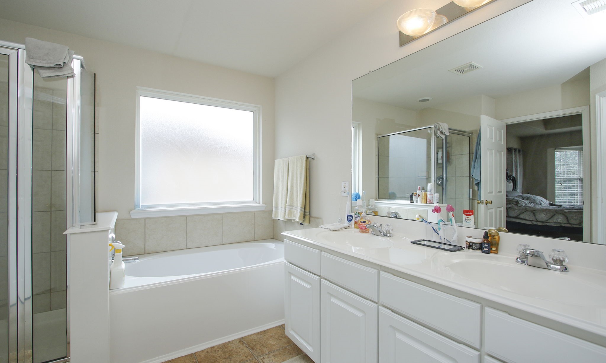 1031 Spring Heights Drive Spring, TX 77373 - Photo 27 of 41 a bathroom with a tub a sink and a window
