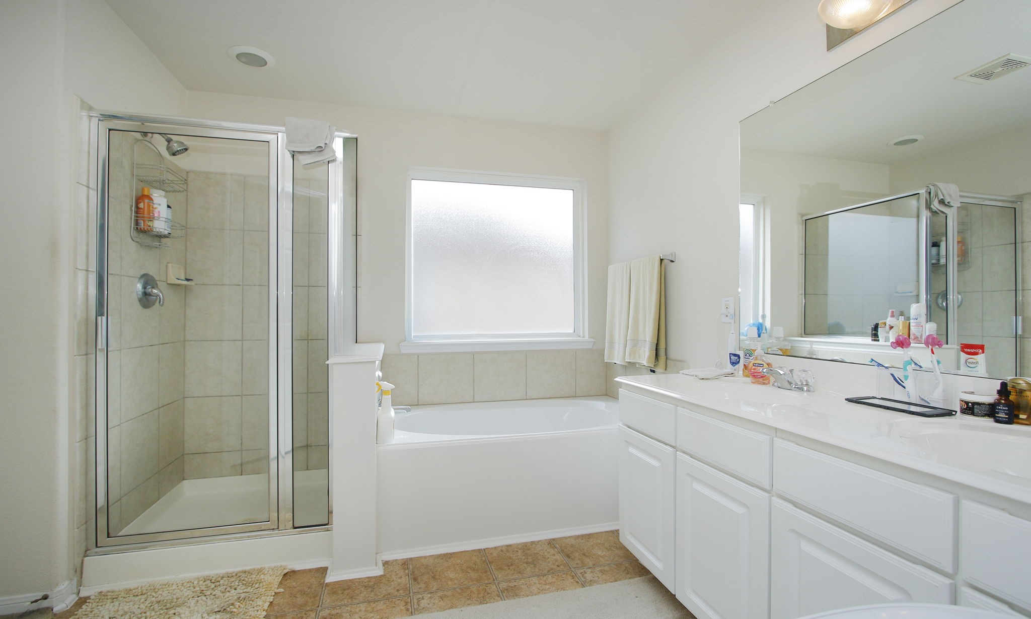 1031 Spring Heights Drive Spring, TX 77373 - Photo 28 of 41 a bathroom with a bathtub shower sink vanity and mirror