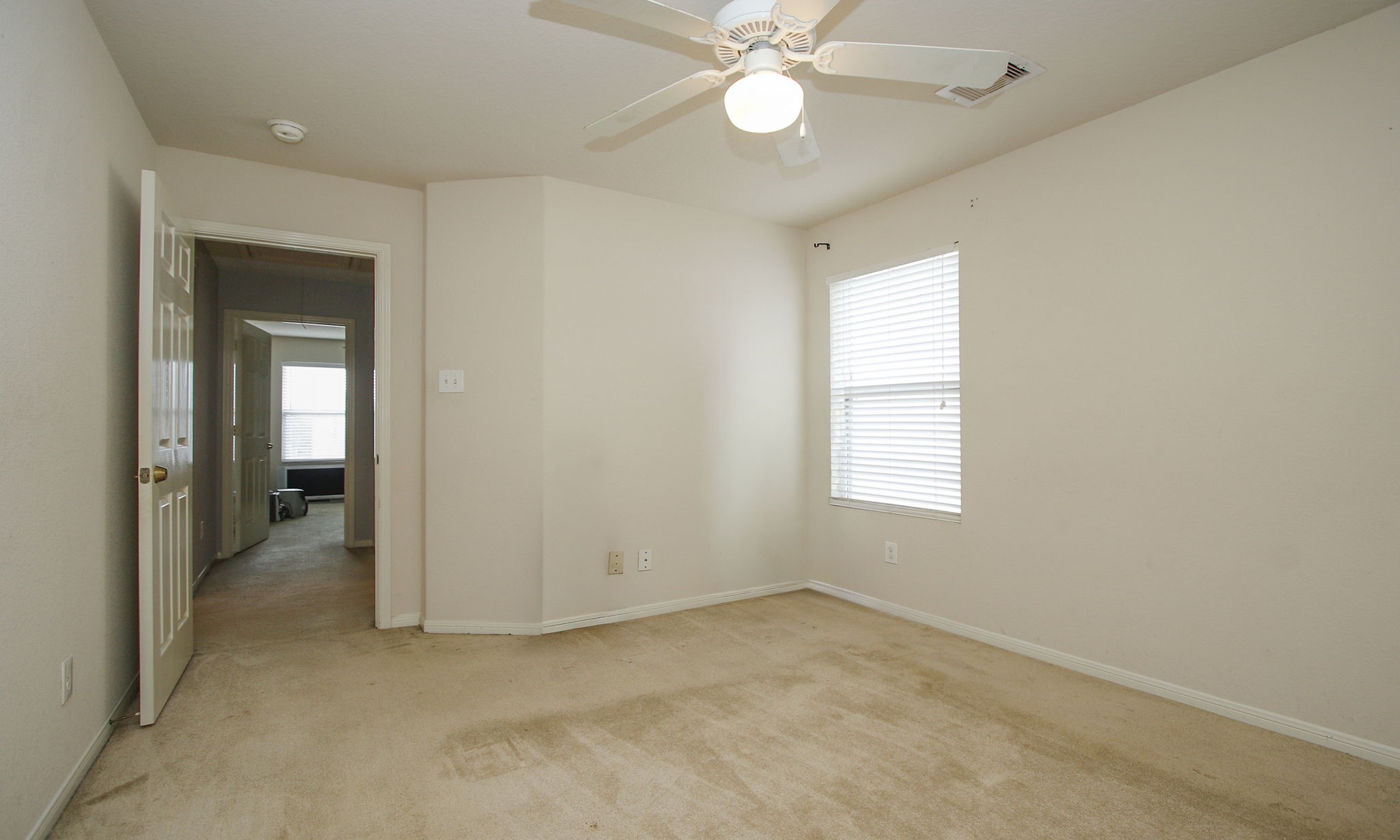1031 Spring Heights Drive Spring, TX 77373 - Photo 33 of 41 an empty room with a ceiling fan and a window