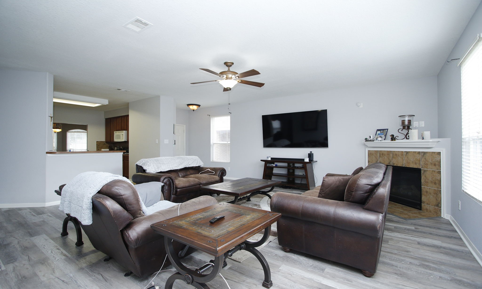 1031 Spring Heights Drive Spring, TX 77373 - Photo 9 of 41 a living room with furniture a fireplace and a flat screen tv