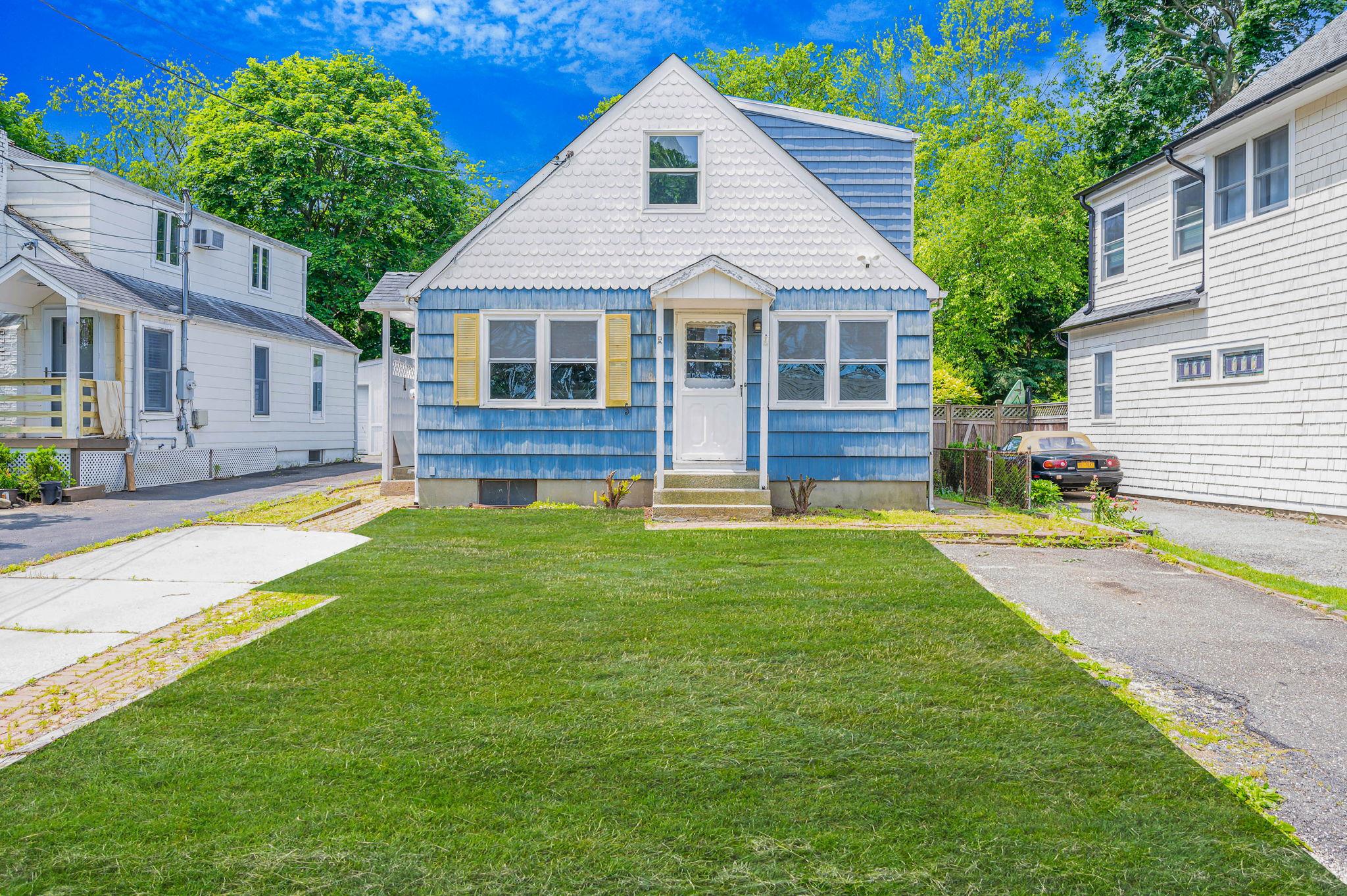 a front view of house with yard and green space