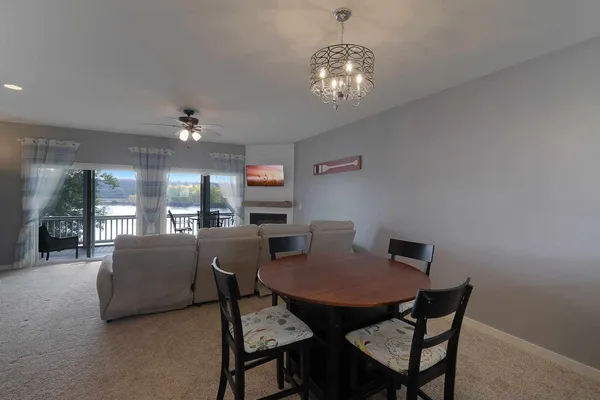 a view of a dining room with furniture and chandelier