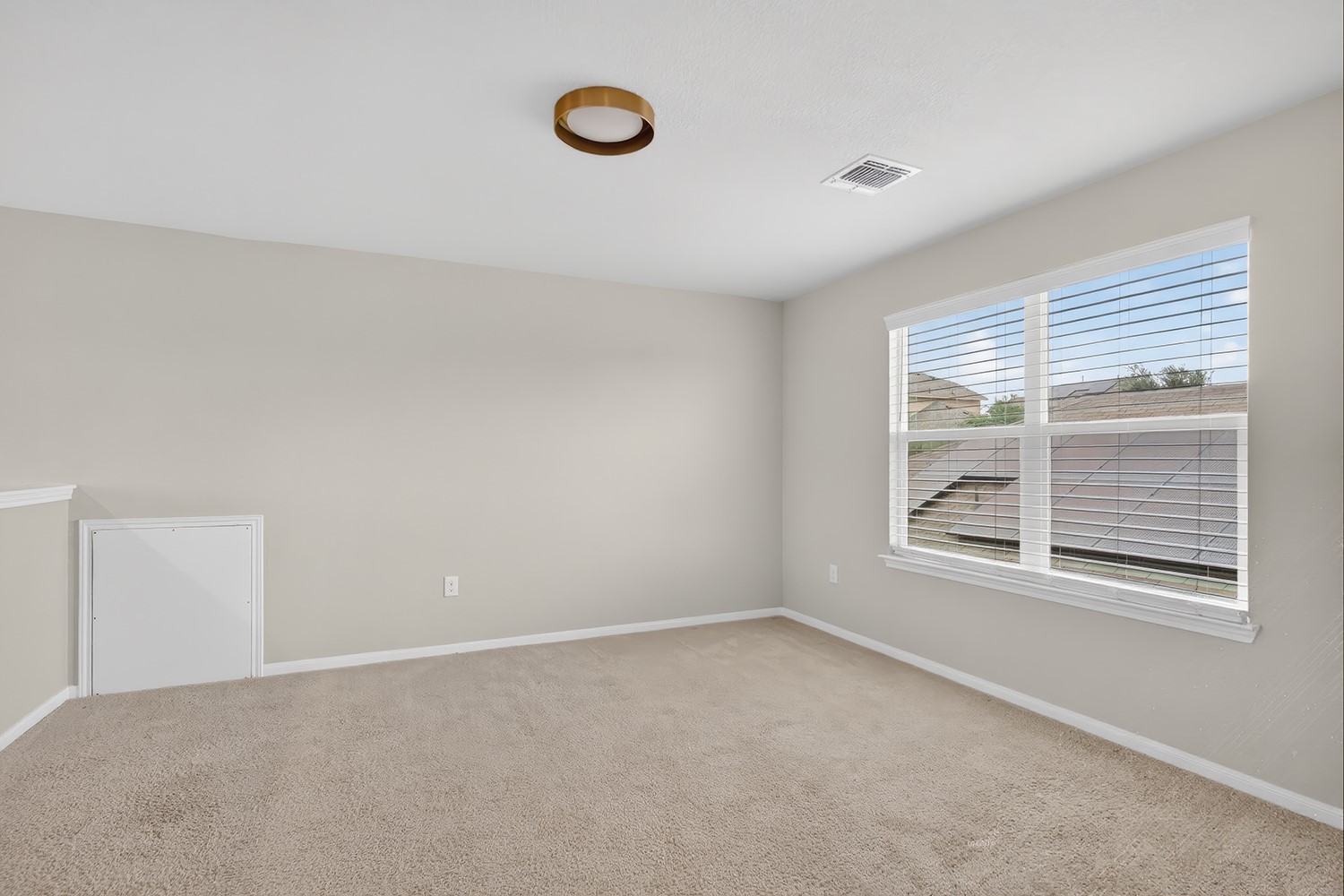 2006 Grow Lane Austin, TX 78754 - Photo 18 of 40 A well-lit, neutral-toned room features a wide window, offering ample natural light.