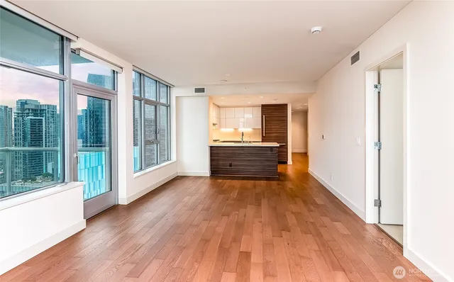 a view of room with wooden floor and floor to ceiling window
