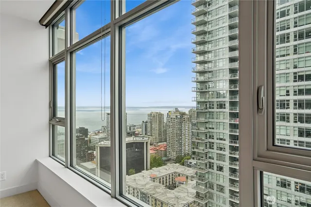 a view of balcony with a floor to ceiling window and tree