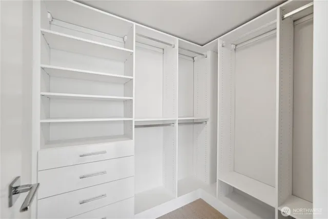 a view of walk in closet with empty racks