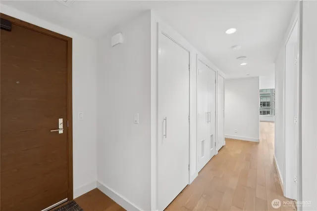 a view of a hallway with wooden floor