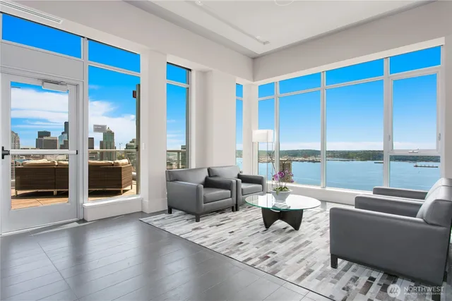 a living room with furniture and a floor to ceiling window
