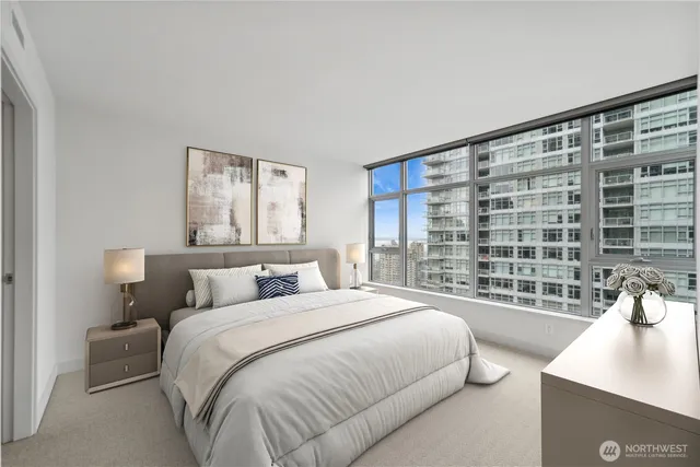 a bedroom with a large bed and a window