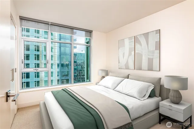 a bedroom with a large bed and a lamp next to a window