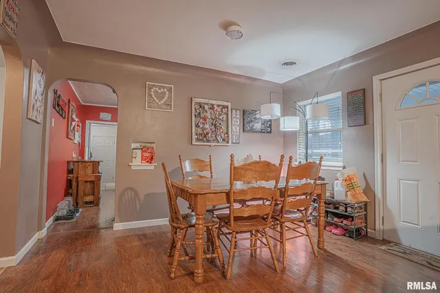 a view of a dining room with furniture and wooden floor