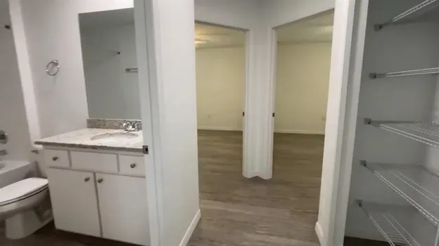 a bathroom with a granite countertop sink toilet and shower