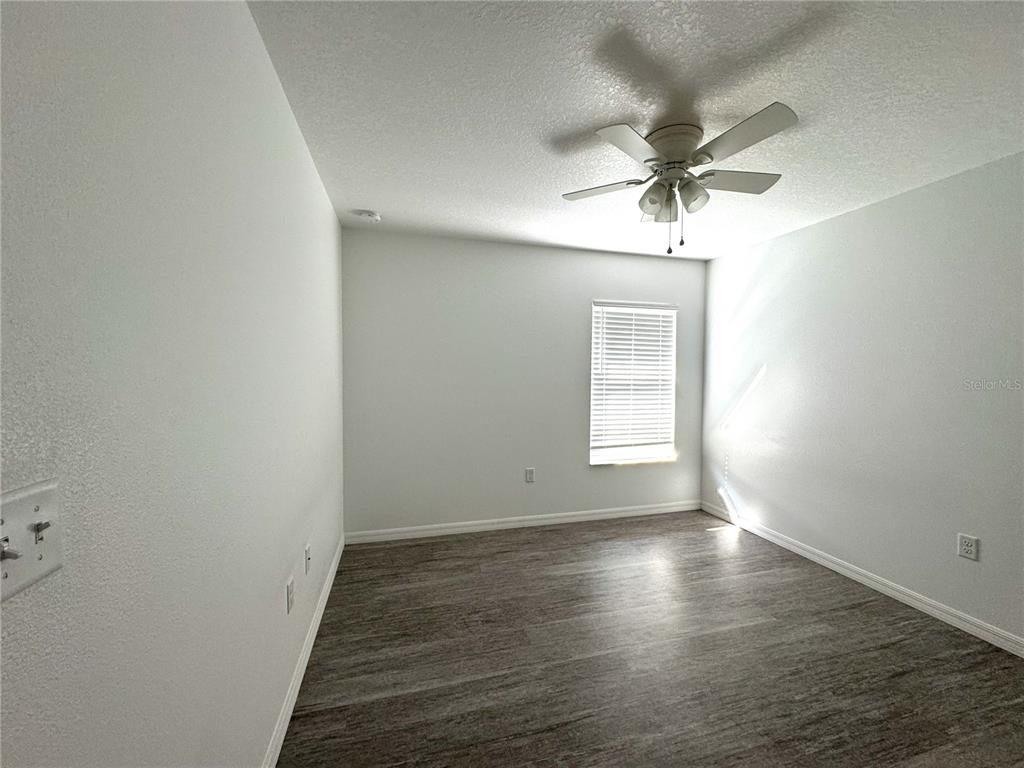 6386 East Rush Street Inverness, FL 34452 - Photo 16 of 21 wooden floor in an empty room with a window