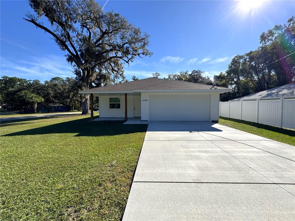 6386 East Rush Street Inverness, FL 34452 - Photo 20 of 21 a front view of a house with a yard