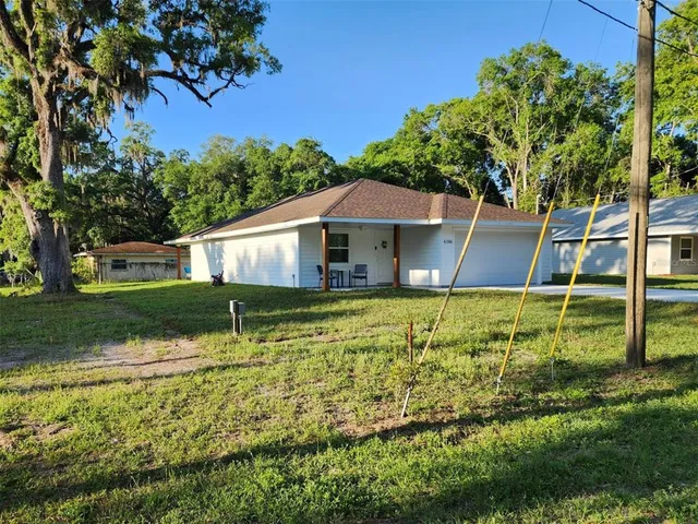 a house with green field in front of it