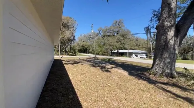 a view of a house with a backyard