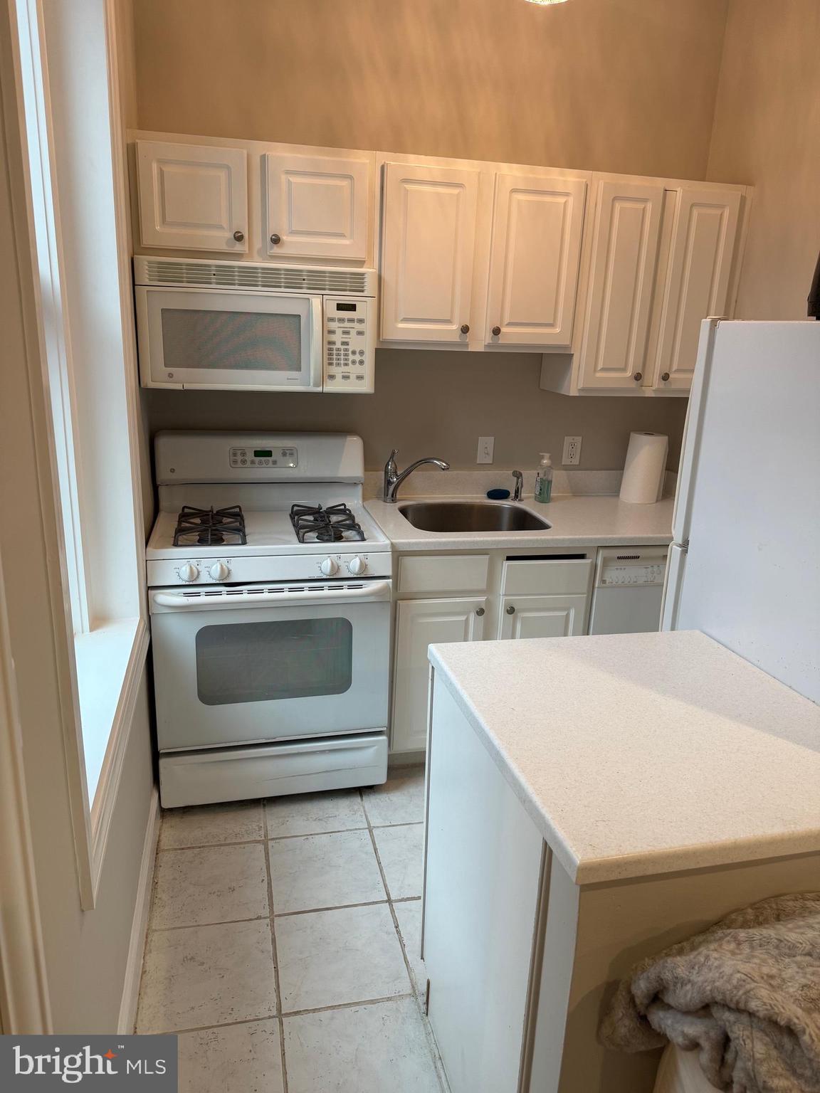 333 2nd Street Northeast, Unit 305 Washington, DC 20002 - Photo 11 of 17 a kitchen with a stove sink and cabinets