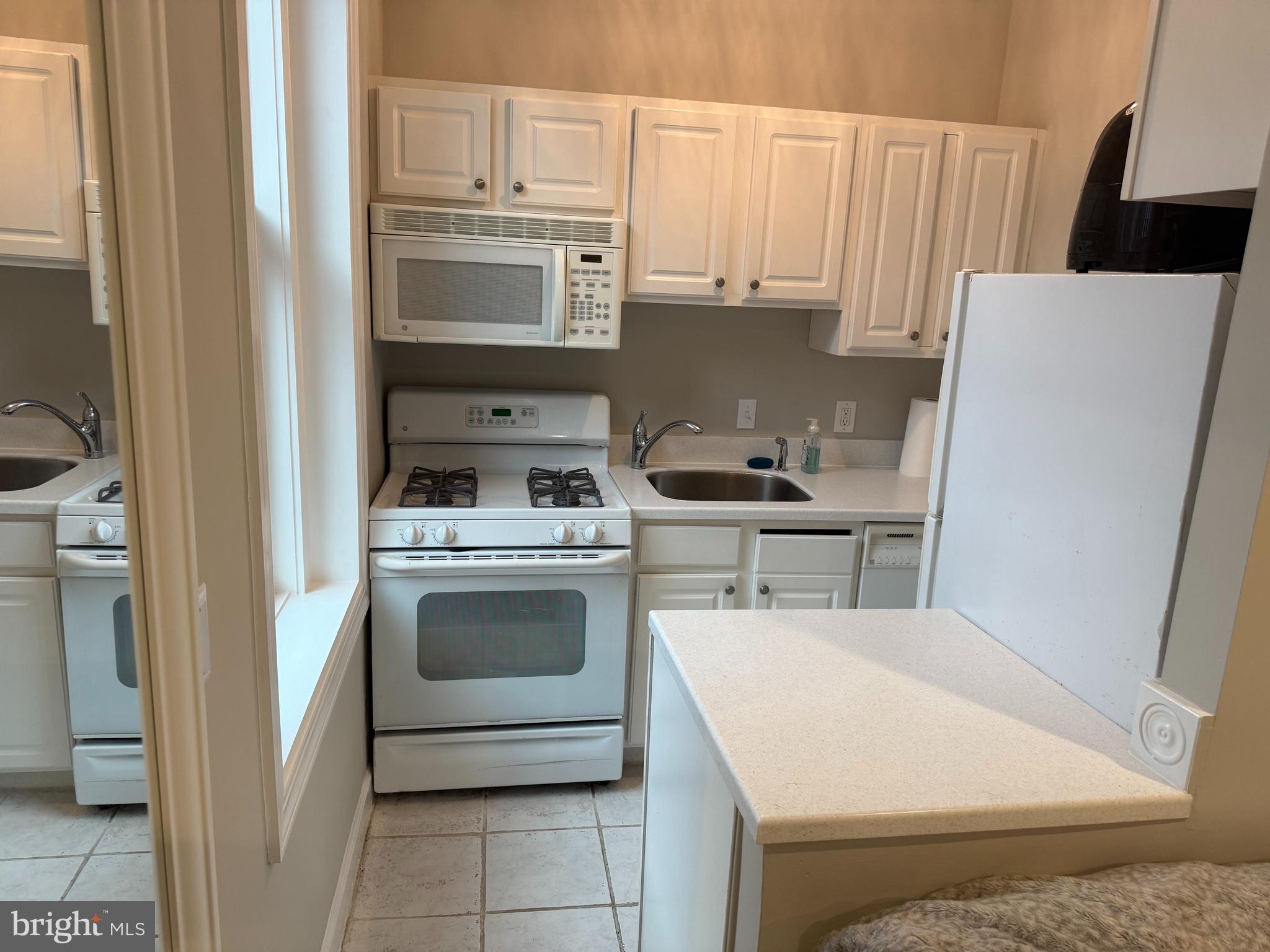 333 2nd Street Northeast, Unit 305 Washington, DC 20002 - Photo 6 of 17 a kitchen with a stove a sink and a refrigerator